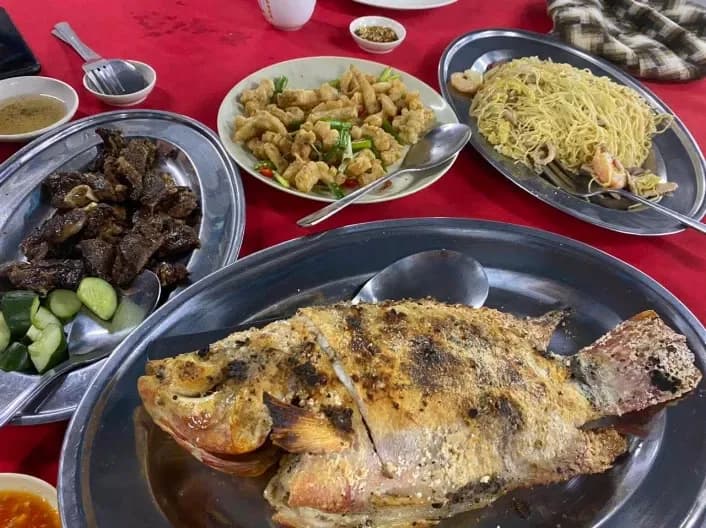 Grilled fish and a full table spread at Shan Deng BBQ